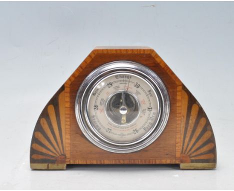 An early 20th century Art Deco oak mantel barometer manufactured by Shortland Smiths. The barometer has a circular dial flank