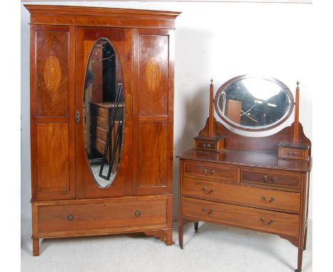 An early 20th century mahogany inlaid Edwardian bedroom suite. The suite comprises a wardrobe with a single mirror door to th