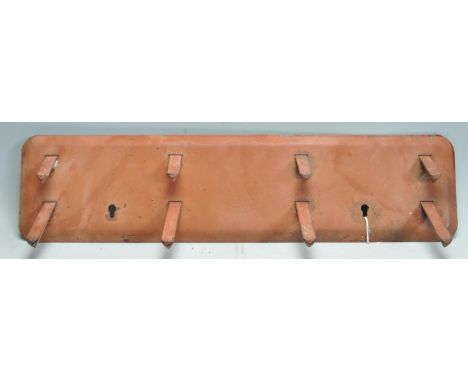 A vintage retro mid 20th century metal wall hanging&nbsp;coat rack by Genyk. The coat rack having eight triangular shaped hoo