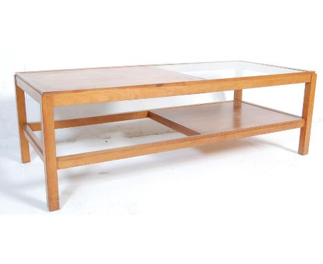 A large retro vintage Danish inspired coffee table. The large coffee table of a rectangular form with glass middle section ra