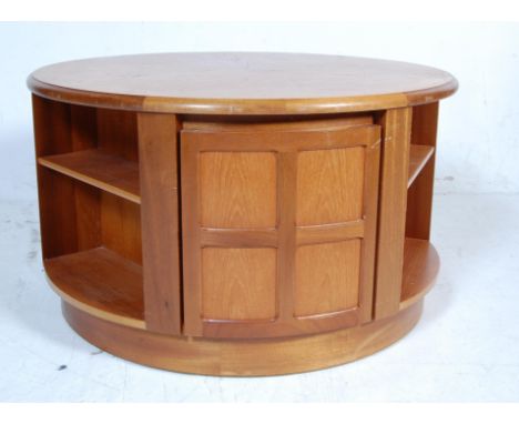 A rare vintage retro 20th century teak wood Nathan revolving coffee table. The coffee table of a circular form with panels do