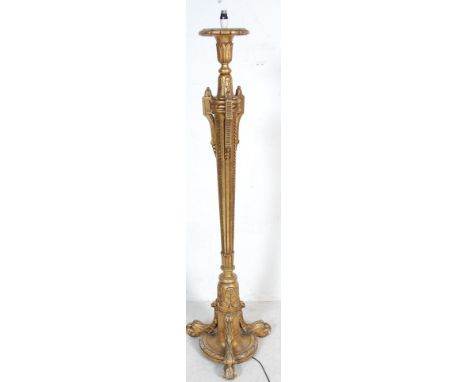 A vintage 20th century Hollywood Regency style standard lamp having a geometric patterned column with floral finials raised o
