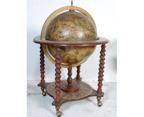 A 1970's / 1980's antique style cocktail drinks globe having with applied terrestrial design with flip top lid, fitted interi