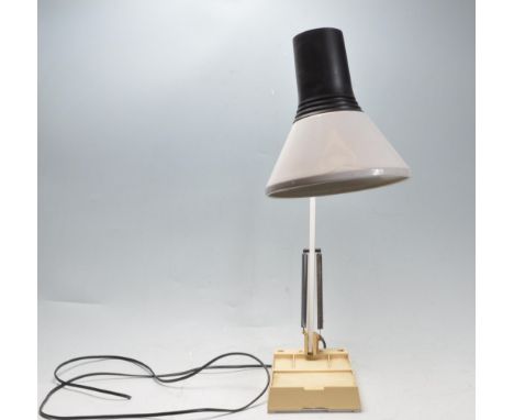 A retro vintage 20th century desk top anglepoise lamp having a two tone shade, two arm support raised on a square plastic bas