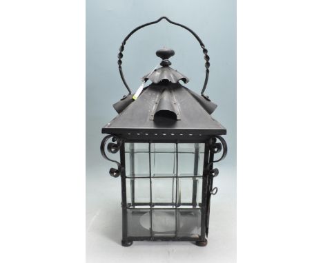 An early 20th century Art Nouveau style metal and glass hanging lantern / porch lantern. The lantern having an arched twisted