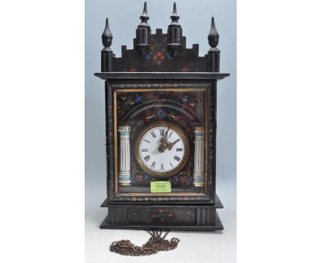 A 19th century Victorian wall hanging clock having a brass and white enamel clock face flanked by two columns. The clock has 