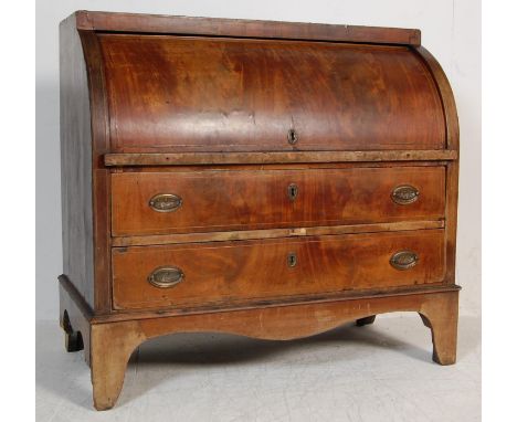 An antique Georgian 18th century mahogany cylinder bureau having boxwood inlay with a roll top flap opening to reveal a fully