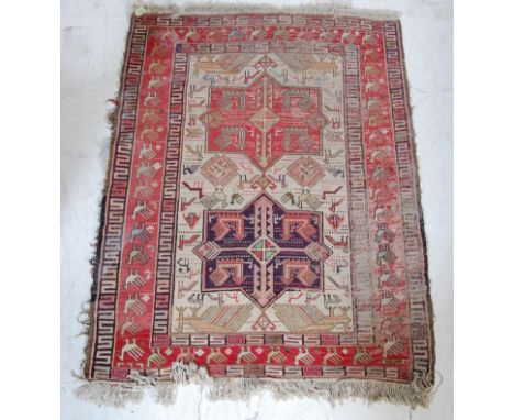 A vintage 20th century South American rug having polychrome geometric detailing with zoomorphic patterns throughout.