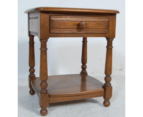 A vintage retro 20th century beach and elm Ercol bed side table / cabinet. The table having a square top with rounded edges a