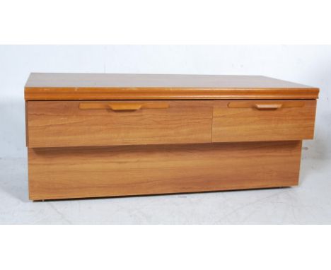 A retro vintage 1970s late 20th century teak wood lowboy sideboard having lipped handles raised on a recessed base. Measures.