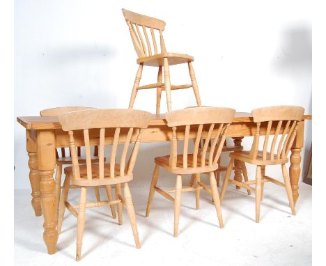 A large vintage pine refectory table and six chairs having a flared top over a recessed frieze raised on turned supports. The