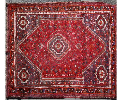 A mid 20th century Persian Islamic Kashan handwoven wool carpet rug having a diamond shaped medallion to the centre with foli