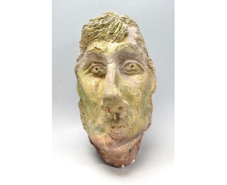 A vintage 20th century garden plaster&nbsp; garden ornament in the form of a stylised mans head. Signs of wear and tear comme