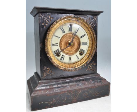 A late 19th century early 20th century ebonised metal 8 day mantel clock of architectural form having a flared top with a bra