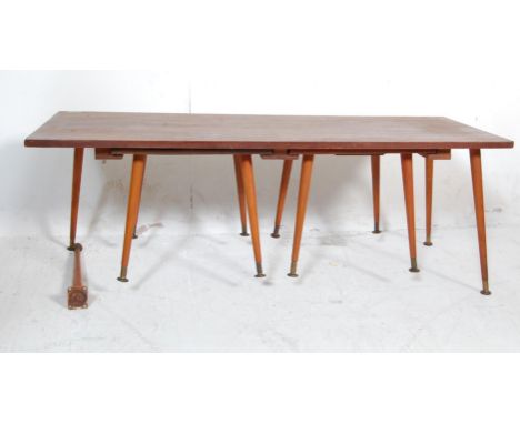 A retro vintage late 20th century teak wood nest of tables having a rectangular coffee table with two subsidiary tables under