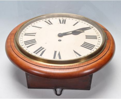 An antique late 19th century Victorian mahogany station wall hanging / postman's / railway clock having a circular mahogany s