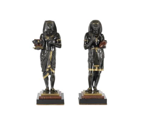 Emile Louis Picault (French, 1833-1915): A pair of patinated and parcel gilt and rouge and black marble figures of an Egyptia