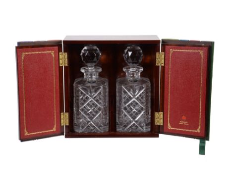  A mahogany decanter case,   two faux leather book doors, opening to two cut glass decanters, 28cm high 