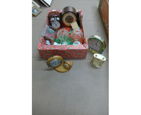 Assorted clocks and two glass light shades 
