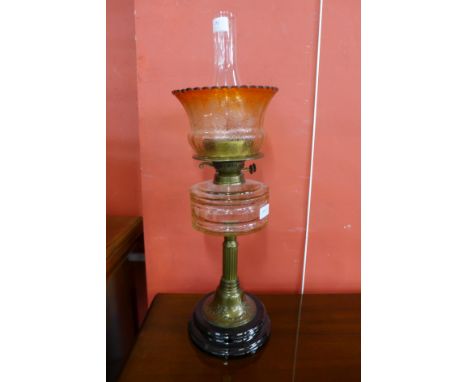 A Victorian brass oil lamp, with glass reservoir and decorated shade 