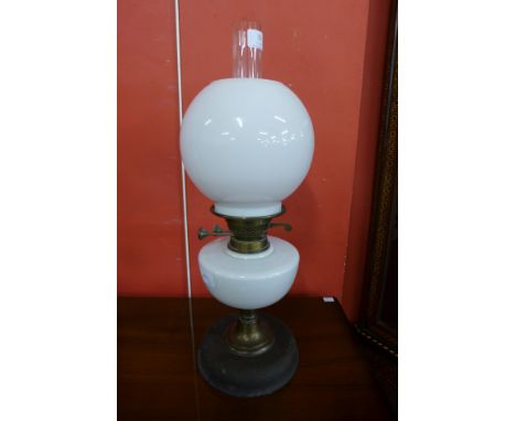 A Victorian brass oil lamp, with opaque glass reservoir and shade 