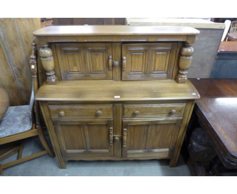An Ercol Golden Dawn court cupboard 