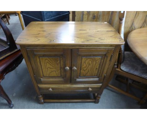 An Ercol Golden Dawn credence cupboard 