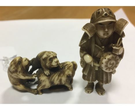 Two Japanese carved ivory Meiji period Netsuke, one carved as a warrior beating a drum the other as group of puppies or bears