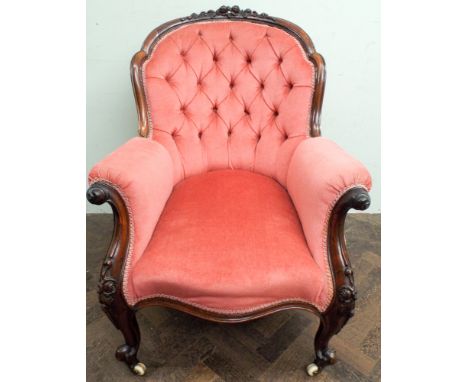 Victorian walnut framed pink button upholstered elbow chair standing on cabriole legs 