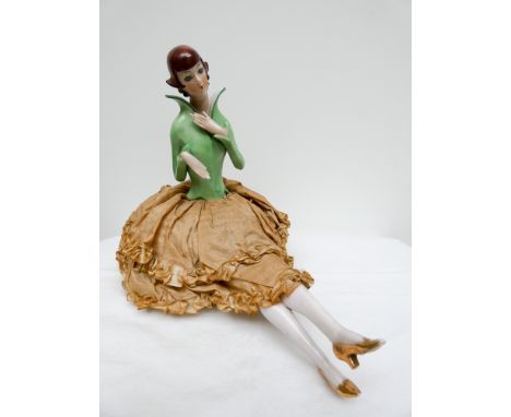 Art Deco porcelain pin cushion half doll wearing a green high necked blouse approx 20cms tall  One leg is broken, top half in