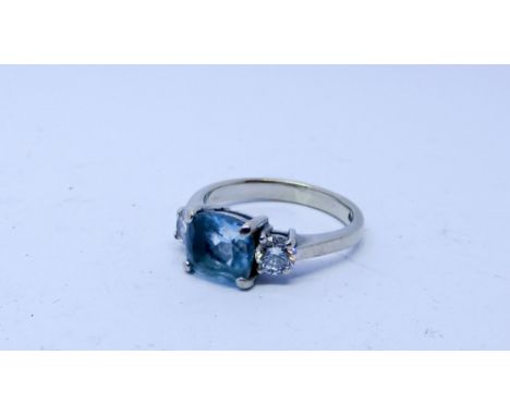 Aquamarine and diamond three stone ring set with a cushion cut aquamarine flanked each side with a brilliant cut diamond, rin