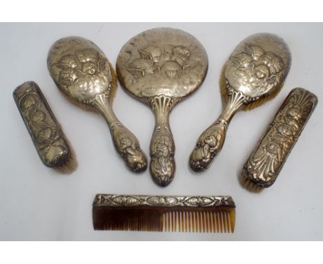 Six piece Edwardian silver Reynolds cherubs decorated dressing table set comprising four brushes, hand mirror and comb 