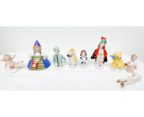 A group of eight vintage miniature pin cushion half dolls  There is a chip to red and black doll, the angel has a repaired ar
