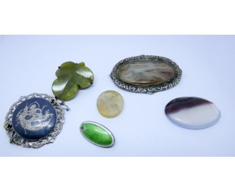 Carved agate intaglio panel, moss agate mounted brooches and a silver Middle Eastern brooch (six)
