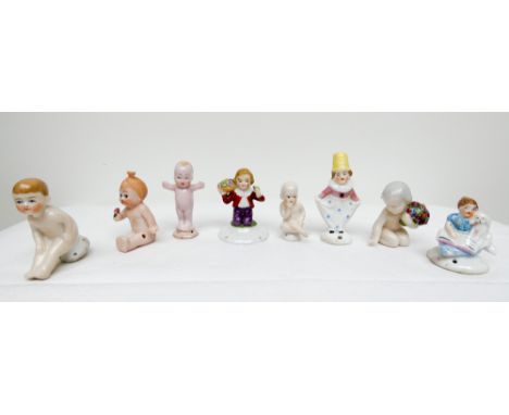 A collection of eight miniature Art Deco porcelain half dolls featuring Kewpie dolls and infants   All in good condition 