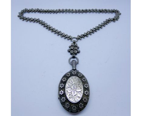 Victorian silver oval ornate locket on a fancy ling and ball chain, locket 6cms long including suspension loop 