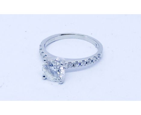 Modern solitaire diamond engagement ring set with a circular brilliant cut diamond of approx 1 ct in a raised Tiffany style c