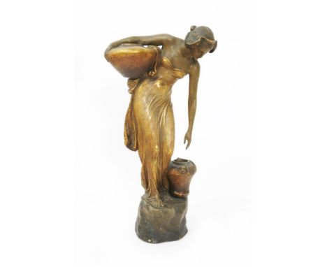  An Art Nouveau Goldscheider Pottery figure of a woman cast from a model by E Tell, model no.2357, modelled stopping to lift 