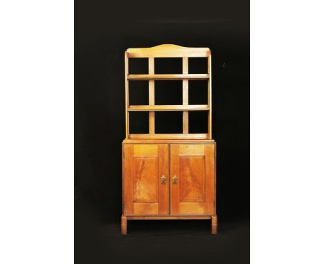  A walnut cupboard with bookshelves by Peter Waals, the twin compartment cupboard with single shelf, patinated hinges and han