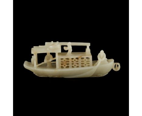 CELADON JADE CARVING OF A BOAT  carved in the form of a flat-bottomed boat above swirling waves, the bow covered with a ratta