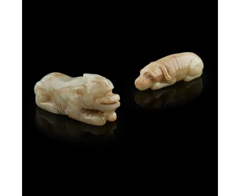 PALE CELADON JADE MODEL OF A HOUND  the hound shown in a recumbent position with head resting on the forelegs and tail swept 