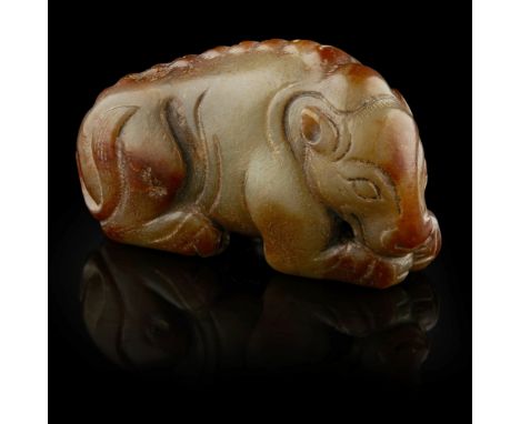 JADE CARVING OF A BEAR  the bear shown recumbent with head facing forward with a pronounced snout, the body incised with S-sh