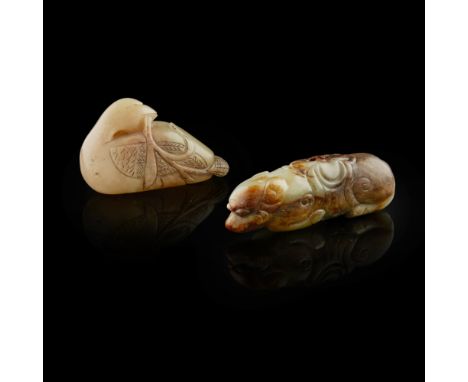 GREEN AND RUSSET JADE PENDANT IN THE FORM OF A HOUND  the animal shown in a recumbent position with legs tucked beneath the e