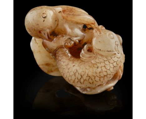 JADE CARVING OF AN OWL CATCHING A CARP  depicting the dramatic moment of an owl swooping from the sky and plucking a carp fro