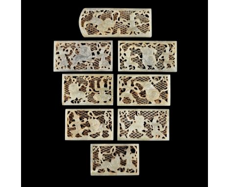 GROUP OF EIGHT CARVED AND PIERCED CELADON JADE BELT PLAQUES  each carved with one or two male warriors dancing with a Buddhis