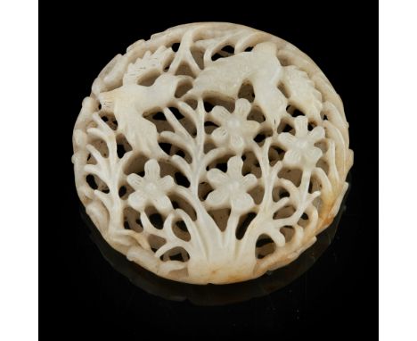 FINELY CARVED AND PIERCED CIRCULAR JADE PENDANT  finely carved and pierced on the one side with a crane in flight amongst pin