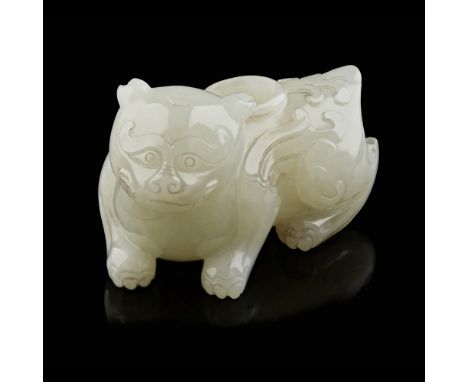 SMALL CELADON JADE WASHER IN THE FORM OF A MYTHICAL BEAST  the recumbent beast with a lion-head and feathered wings, the well