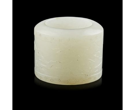 PALE CELADON JADE ARCHER'S RING, BAN ZHI  of characteristic cylindrical shape, carved in low relief with a flowering prunus t