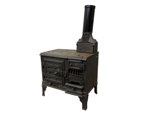 A cast iron stove, 'The Holloway', with hot plates to the surface and two ovens, with flue, raised on bracket feet, 43 by 67 