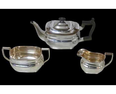 A George V three-piece silver tea set, comprising teapot, 28 by 12 by 13cm high, twin handled sugar bowl, 18 by 9.5 by 9cm hi
